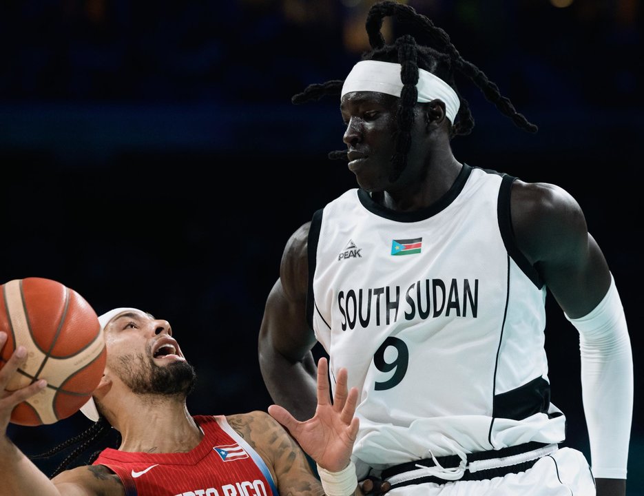 Stephen Thompson Jr. de Puerto Rico, y Wenyen Gabriel, de Sudán del Sur, durante el partido de este domingo. EFE/EPA/ALEX PLAVEVSKI