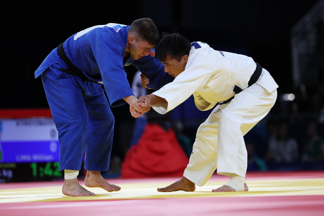 El judoka kazajo Gusman Kyrgyzbayev (blanco) compite ante el brasileño Willian Lima en un combate de semifinal del Cuadro B de Judo Masculino en la categoría de -66 kilos de los Juegos Olímpicos de París 2024 este domingo en París. EFE/ Miguel Gutiérrez