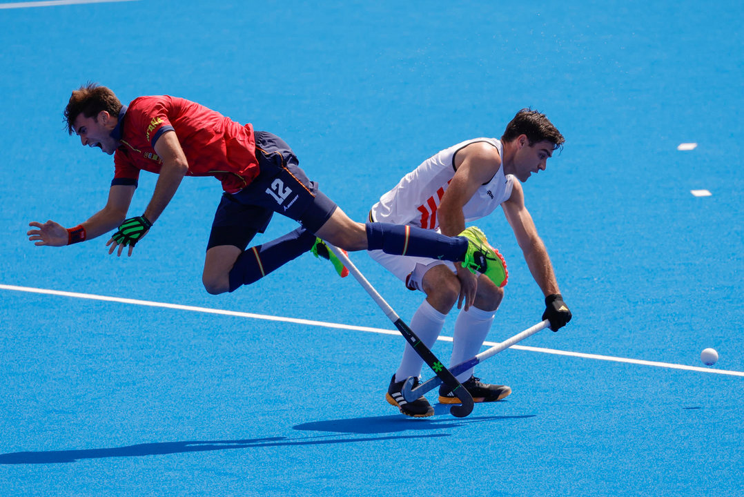 El jugador de la selección española masculina de Hockey Hierba Marc Reyne (L) cae ante el belga Thibeau Stockbroekx (R) durante el partido. EFE/Lavandeira Jr